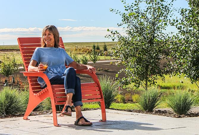 Woman sitting outside on an adirondack chair
